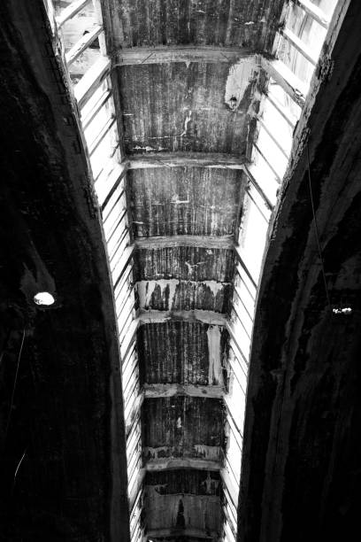 istock Vertical greyscale shot of a rusty ceiling of an ancient building during daytime 1439789566