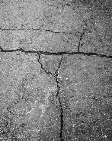 A cracked grey asphalt road - great for a background
