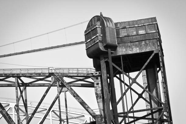istock Greyscale low angle shot of a construction crane under the clear sky 1439789655