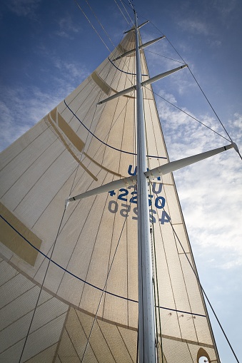 Bayfield, United States – July 30, 2011: A vertical image of a racing sailboat mast under sail on Lake Superior.