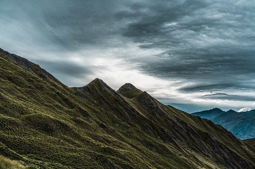 A breathtaking scenery of the historic Roys Peak touching the gloomy sky in New Zealand