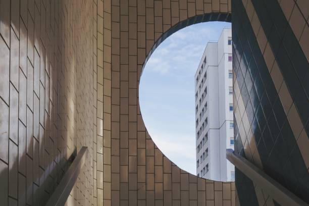 istock White building visible from the round window in a tiled building 1439790281