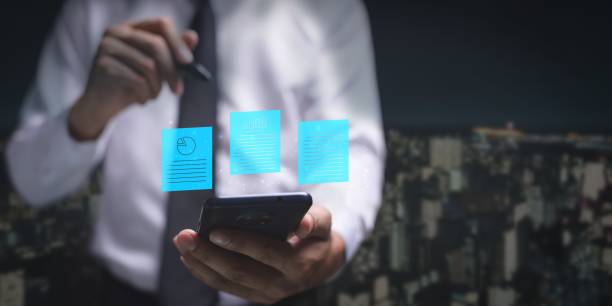 istock Illustrative digital document floating above a smartphone in a businessman's hand 1439791065