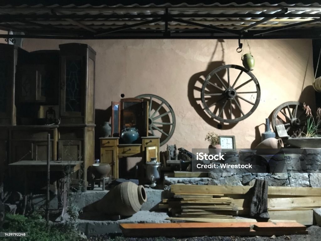 Old attic with ancient goods, wooden shelf, steering wheel, and wood planks An old attic with ancient goods, wooden shelf, steering wheel, and wood planks Antiquities Stock Photo