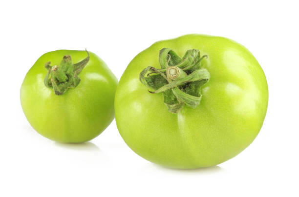 istock Two shiny green tomatoes isolated on white background 1439793845