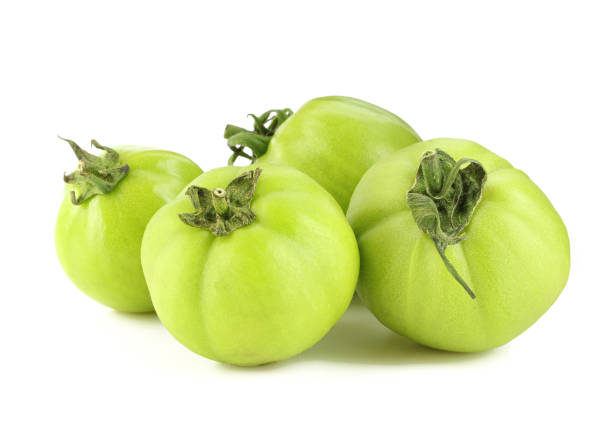 istock Group of green tomatoes isolated on white background 1439793904