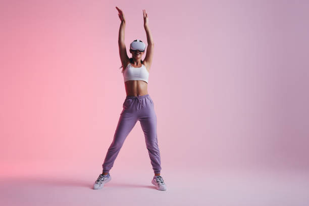 istock Sporty young woman having fun with virtual reality goggles 1439794138