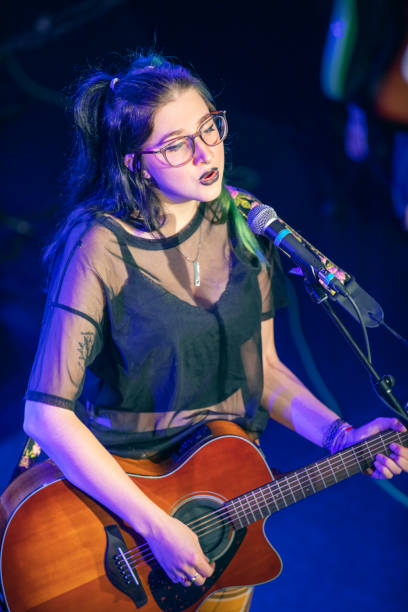 istock Beautiful Young Female Musician Performing Live 1439794245