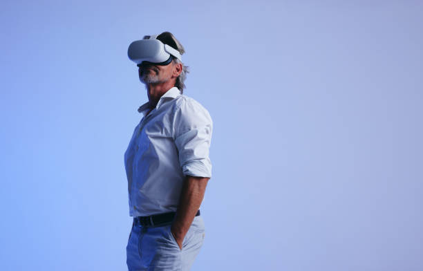 istock Senior businessman wearing a virtual reality headset 1439794284