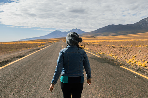 Woman on the road in the Chilean desert