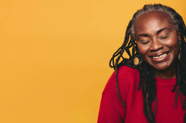 istock Black woman with dreadlocks smiling with her eyes closed 1439794415