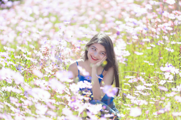 Young latina woman dressed in blue and smiling