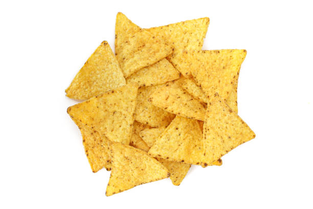 istock Pile of triangle shaped tortilla corn chips isolated on white background 1439795871