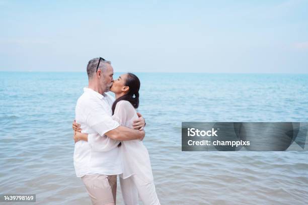 Happy Couple Senior Eldery Retirement Resting At Beach Honeymoon Family Together Happiness People Lifestyle Stock Photo - Download Image Now