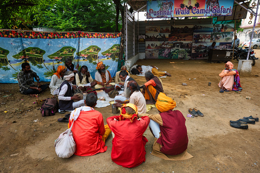Pushkar, India - November 7, 2019: Street musicians playing music in the street of Pushkar, Rajasthan, India