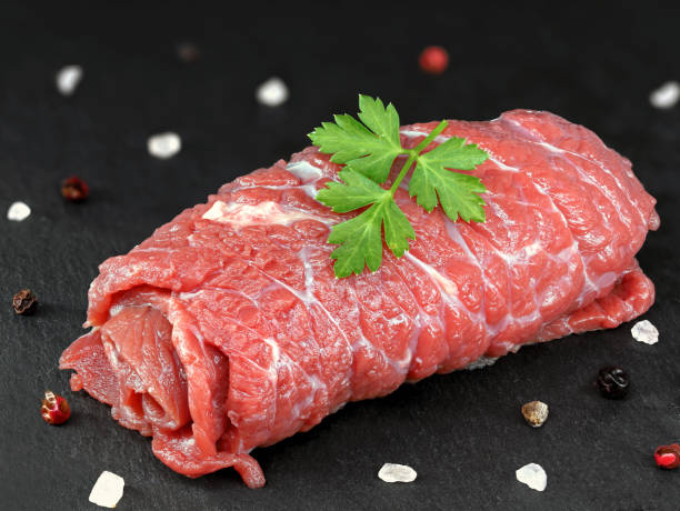 istock single raw unfilled beef roulade with salt and peper on black slate board, traditional german food 1439799115