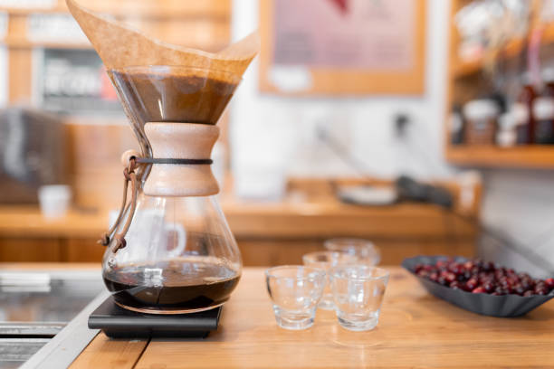 istock Handmade filtered coffee dripping into a pot next to some empty cups 1439799740