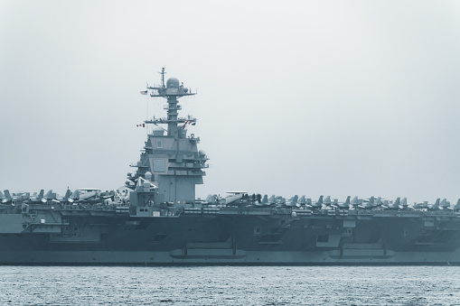 Navy aircraft carrier angled view, with a large compartment of aircraft and crew.