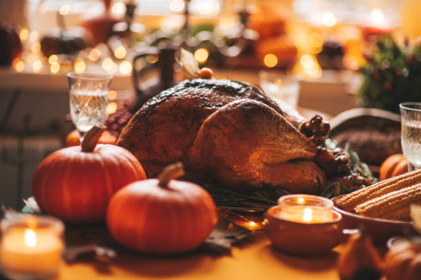 istock Thanksgiving holiday dinner table setting with fall decoration and pumpkins 1439803899