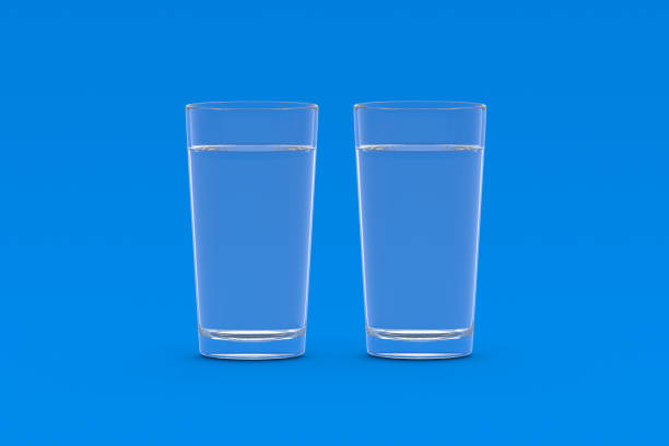 istock Two glasses of water on blue background. 3d render 1439804189