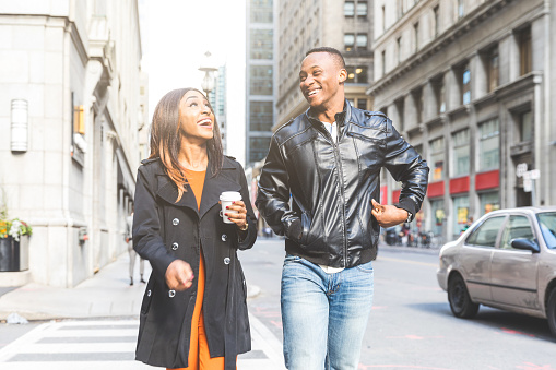 Happy black couple walking in Toronto - Man and woman walking and laughing, enjoying a day out in the city on a sunny autumn day