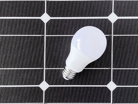 Energy saver lightbulb on a solar cell panel