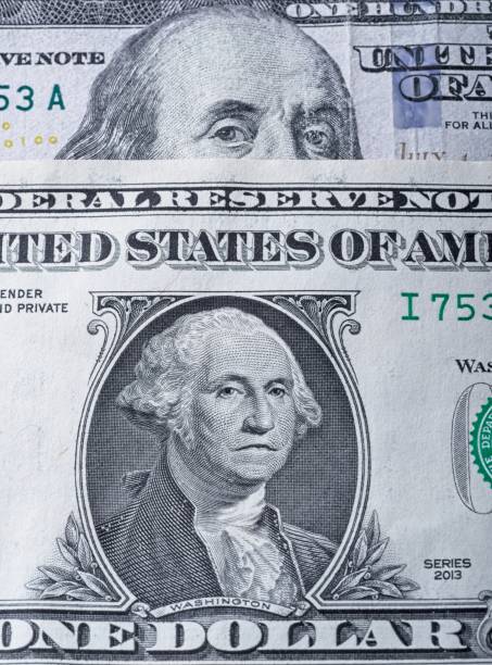istock Benjamin Franklin on a 100 dollar bill appears to be looking over a frowning George Washington dollar bill 1439806588