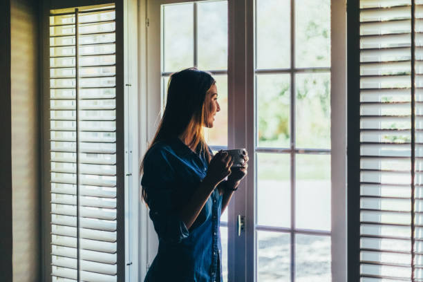 istock Relaxed woman at home drinking coffee 1439806627