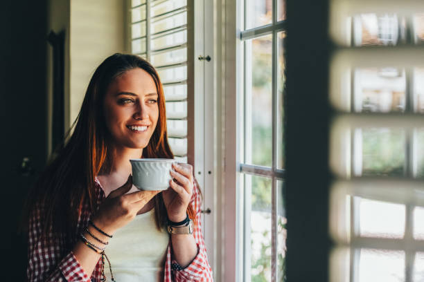 istock Relaxed woman at home drinking coffee 1439806699