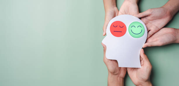 istock Hands holding sad face and happy smiley face on brain paper cut out, bipolar and depression, mental health concept, personality, mood change, therapy healing split concept 1439806849