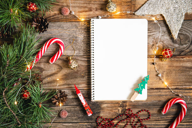 istock Blank notepad and Christmas decor details on wooden background, flat lay. 1439807142