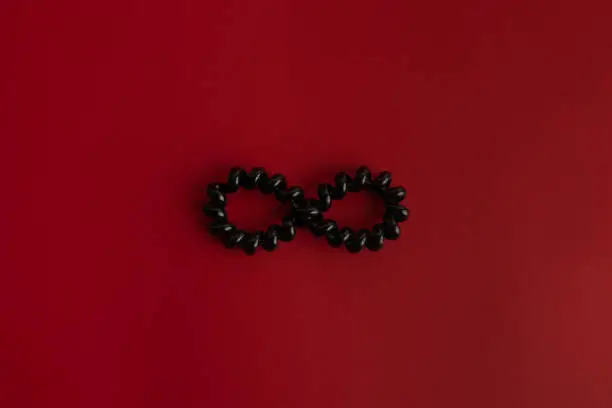 infinite symbol in black on red background
