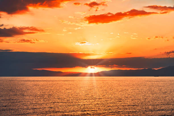 istock Ray of sun at the down on the sea 1439808922