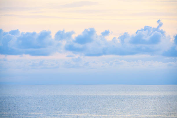 istock Blue clouds on the calm sea 1439809001