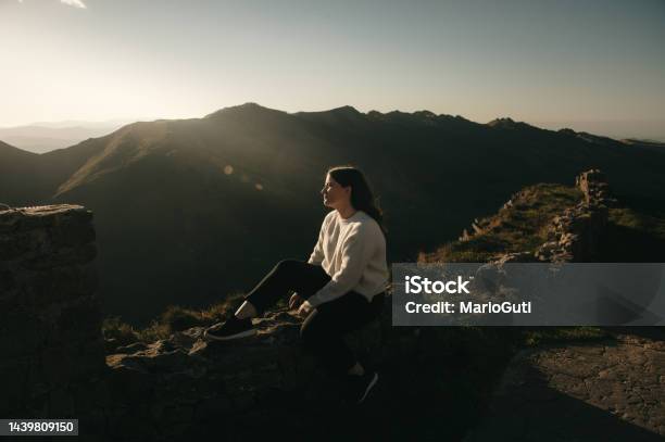 Young Woman Contemplating A Beautiful Mountain Area Stock Photo - Download Image Now