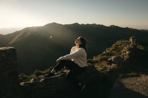 istock Young woman with a relaxed attitude in a mountain area 1439809727
