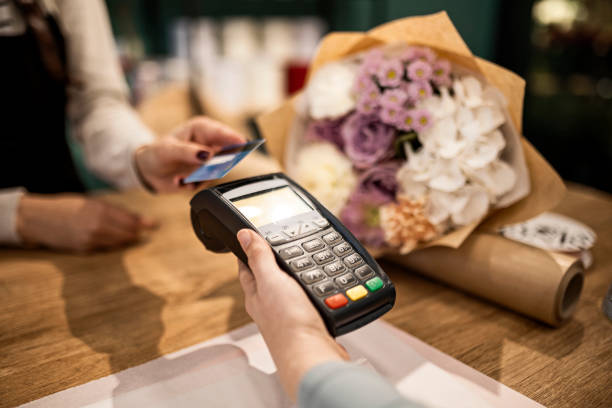 istock Making payment with credit card at flower shop 1439810362