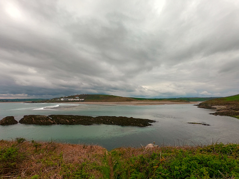 View of Clonakilty Bay on a cloudy day. Gloomy sky over the seashore. Beautiful seascape. The coastline of the south of Ireland.