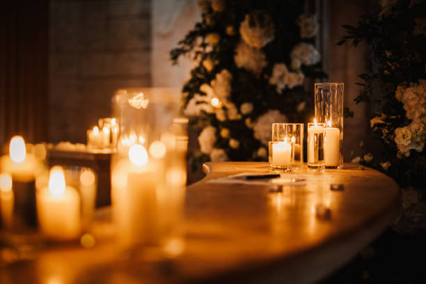 istock Burning candles over old wooden table with bokeh lights 1439811419