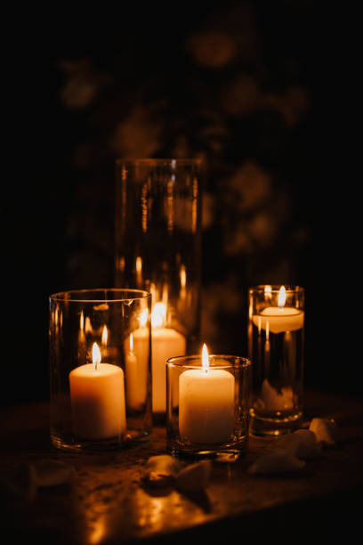 istock Burning candles over old wooden table with bokeh lights 1439811422