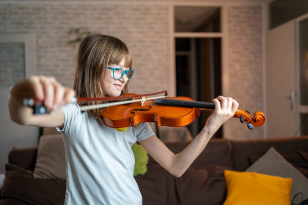 istock Caucasian girl playing violin 1439811495