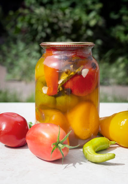istock Canned pepper in a glass jar on the table 1439811674