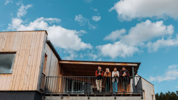 istock Friends enjoy view from mountain cabin. 1439811854