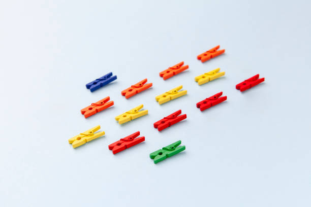 istock Formation of objects forming arrow, repetitive group of clothespin colorful pattern, crowd top view 1439812882