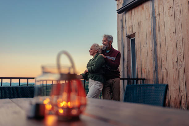 istock Romantic senior couple at mountain cabin. 1439813152