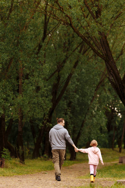 istock Father and daughter walking 1439813893