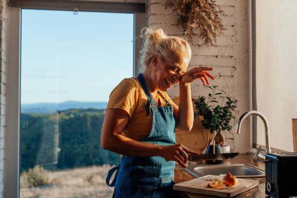 istock Woman crying while cutting onion at home. 1439814255