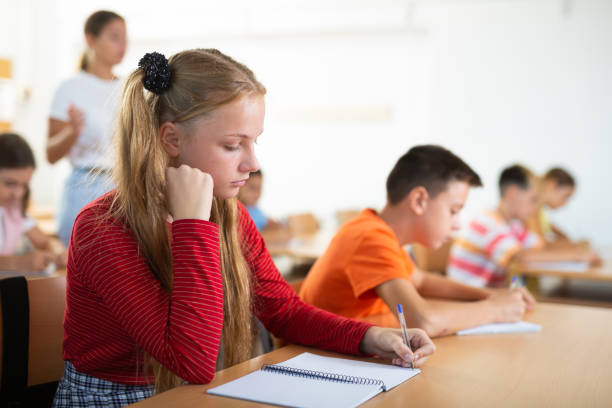 istock Girl studying in school during lesson 1439814583