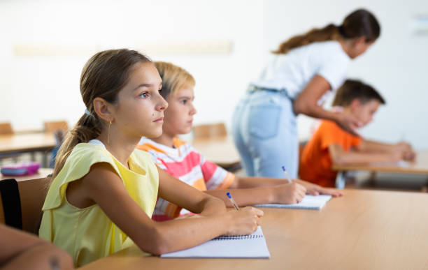 istock Boy and girl studying in classroom 1439815626