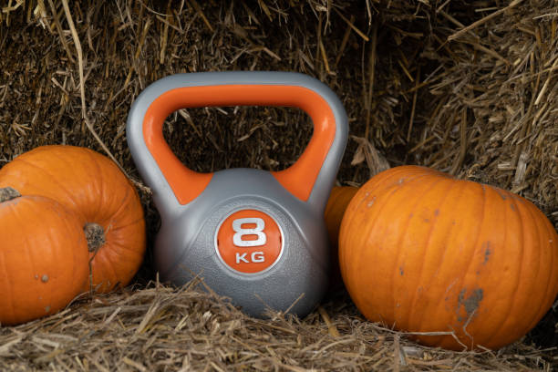 istock Gym kettlebell and pumpkins on a farm, autumn or fall composition. 1439816202